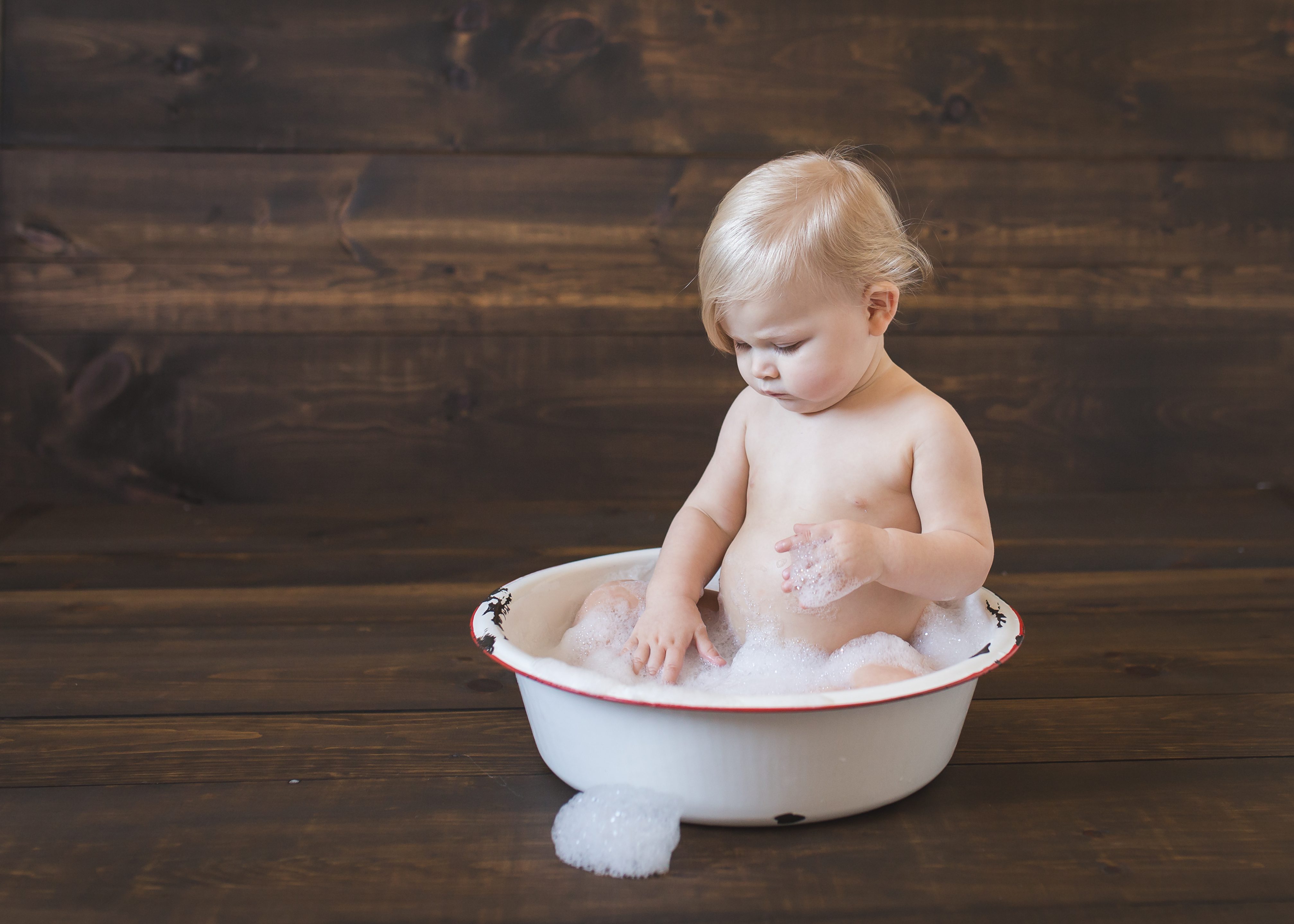 baby girl in antique bowl bubble bath