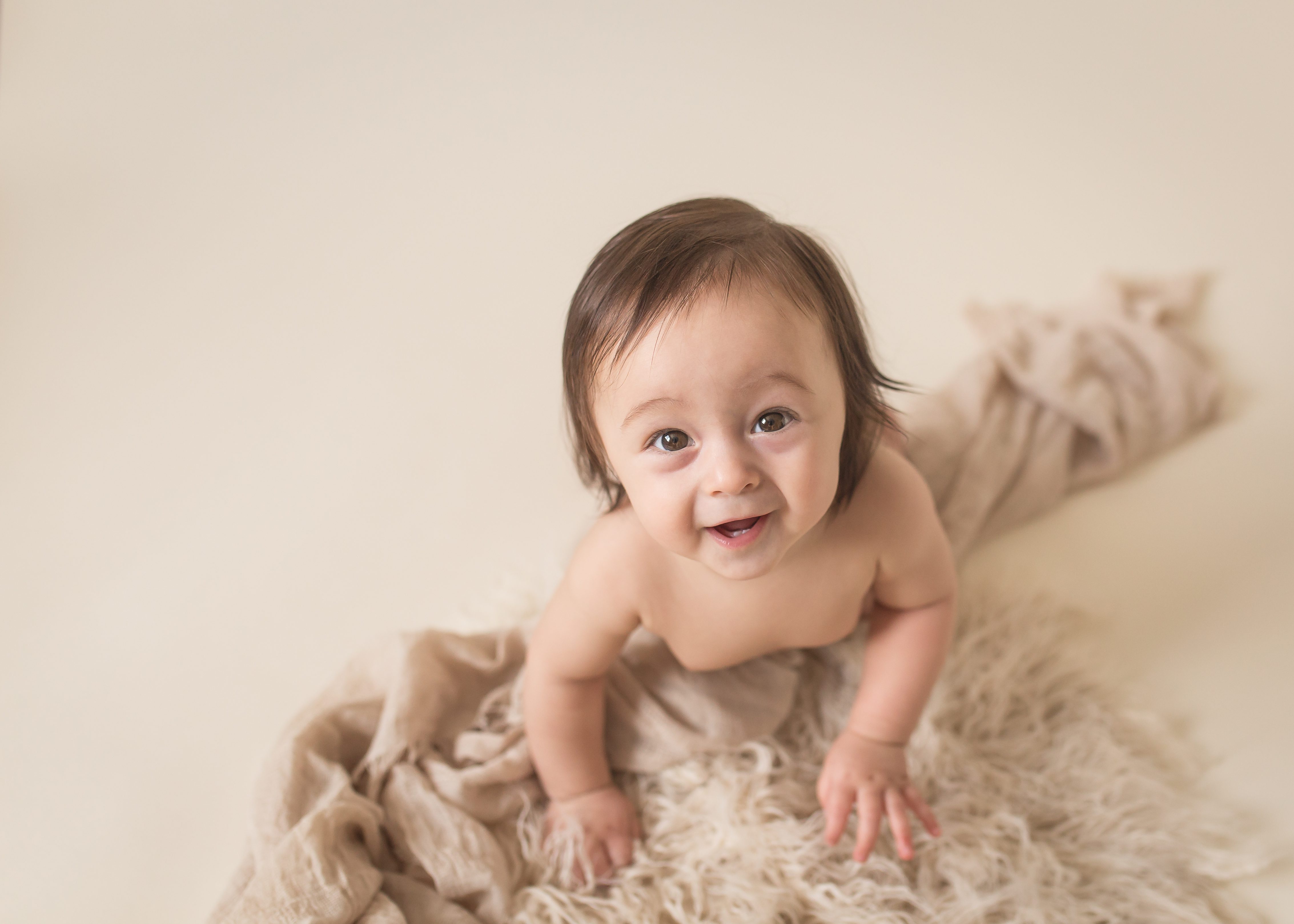 smiling baby on fur and blanket