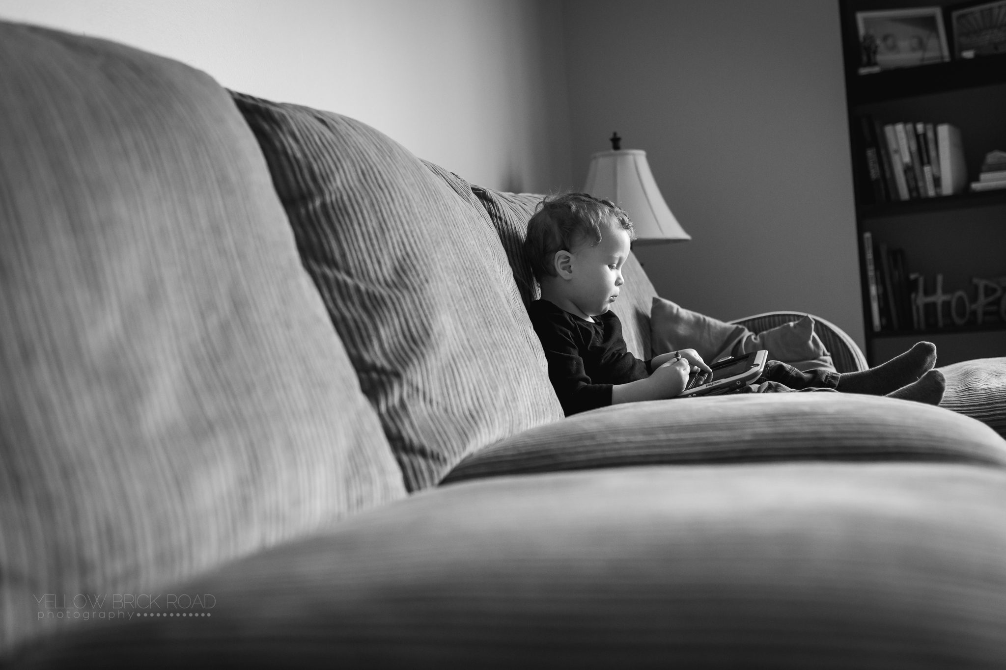 lifestyle image of toddler playing on tablet