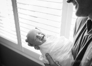 Dad holding smiling new son
