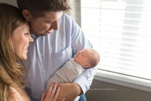 Guelph Newborn Photographer new parents holding baby