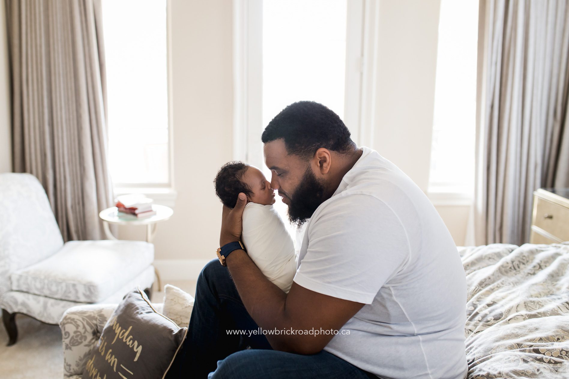 NFL Newborn Photographer Houston Texan Jeff Allen kissing newborn son. www.yellowbrickroadphoto.ca Yellow Brick Road Photography www.yellowbrickroadphoto.ca
