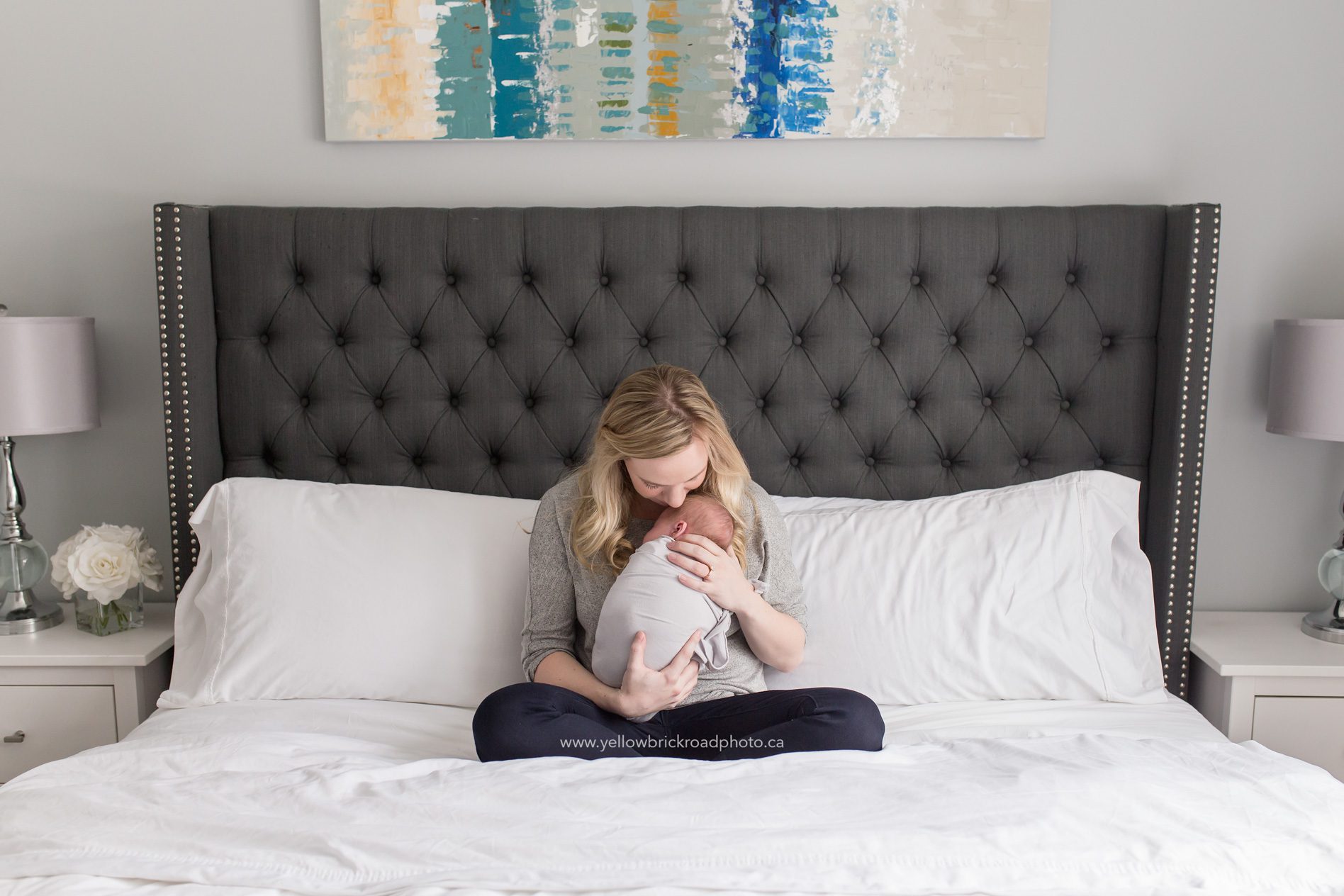 Newborn Lifestyle Session Mom cuddling new baby