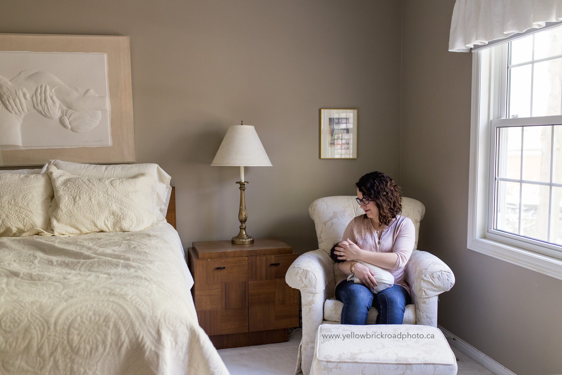 Waterloo Newborn Lifestyle Photographer capturing mom in bedroom with newborn baby