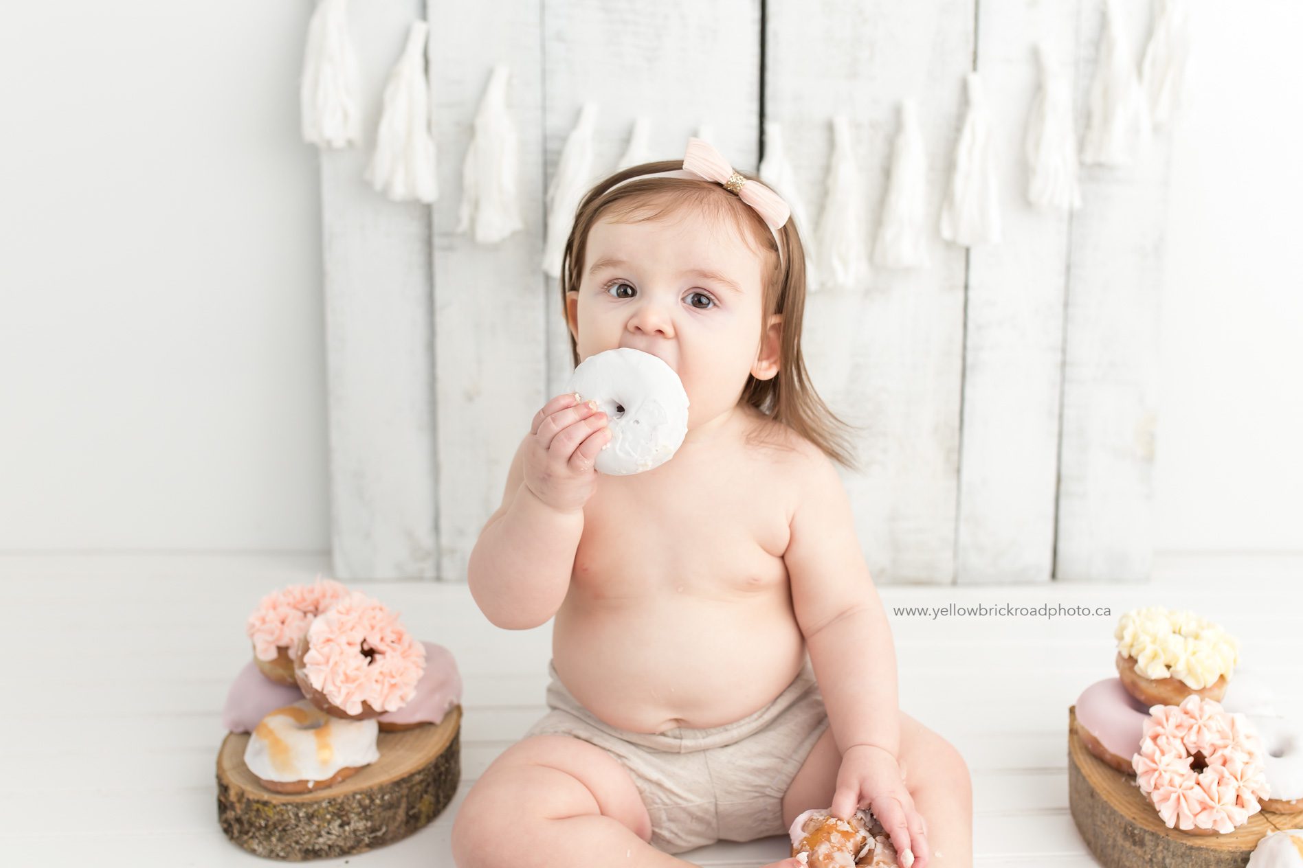 Birthday milestone baby eating white donut