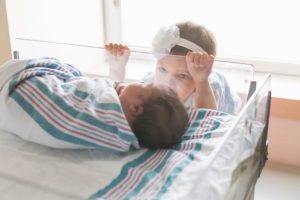 Newborn with sister fresh 48