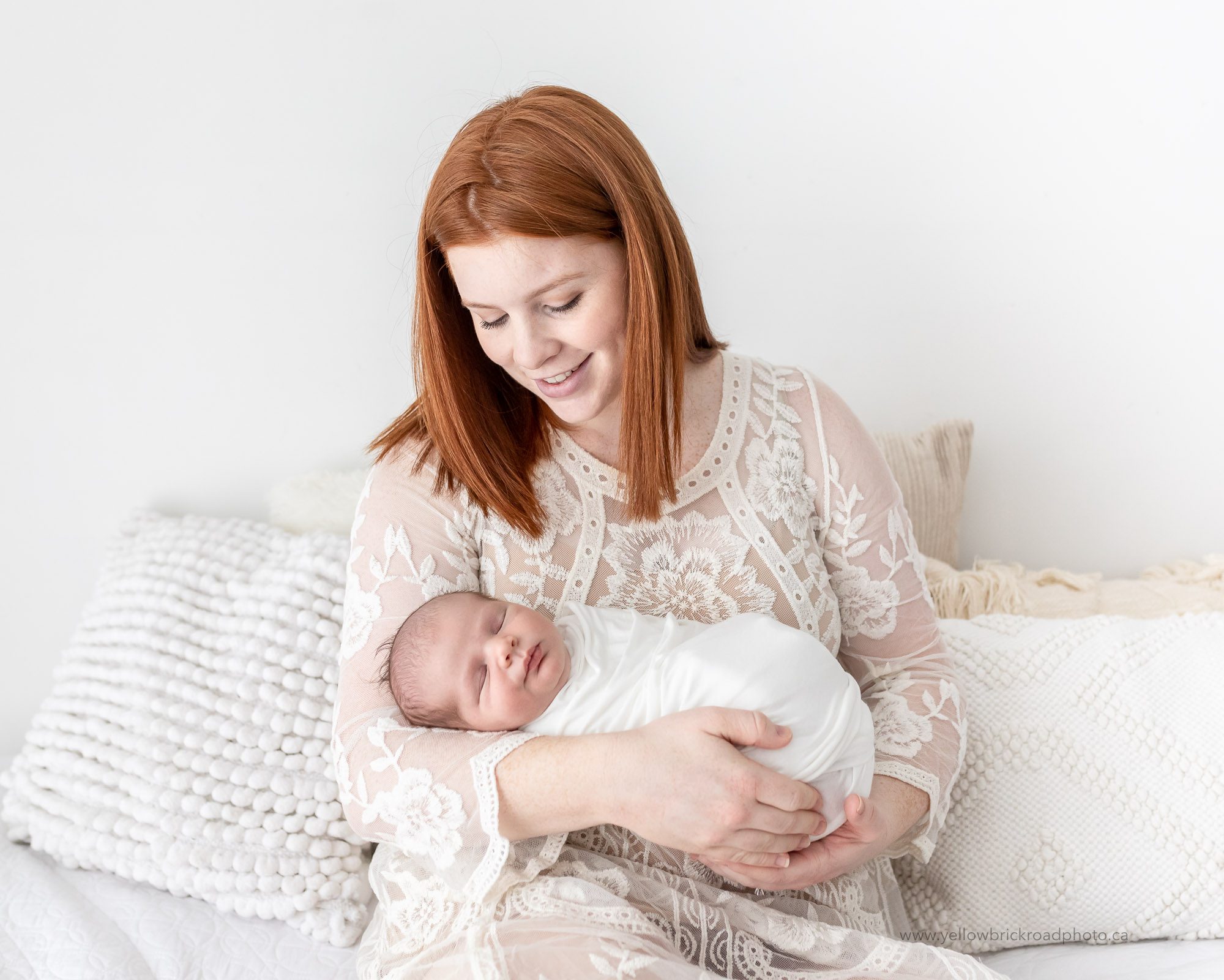 red haired mom holding baby