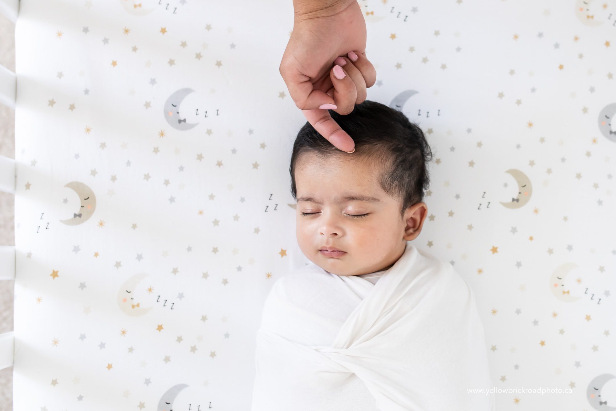 sleeping baby on crib sheet