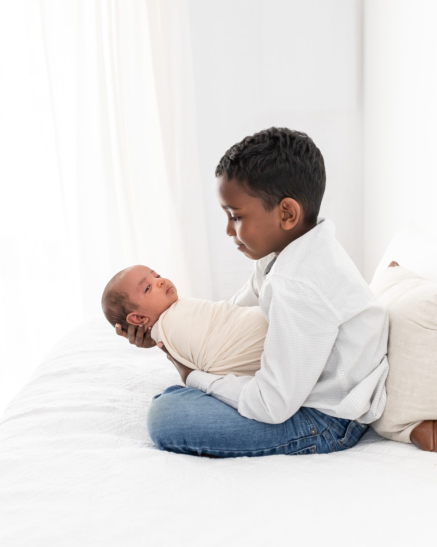 sibling holding new baby sister